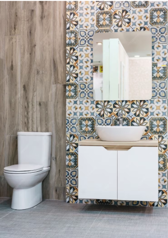 A bathroom with tiled walls and a toilet.